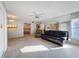Neutral living room offering carpet, wall mirror, ceiling fan and combined dining area with kitchen at 13103 Cypress Hill Dr # B2, Hudson, FL 34669