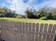 Partially fenced grassy backyard, perfect for outdoor activities and enjoying the natural surroundings at 1817 Dartmouth Dr, Holiday, FL 34691