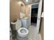 Bathroom featuring mosaic tile floors, vanity with a solid surface countertop, and updated mirror at 1817 Dartmouth Dr, Holiday, FL 34691
