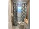 Cozy bathroom featuring mosaic tile floors, patterned shower curtain, and a single vanity at 1817 Dartmouth Dr, Holiday, FL 34691