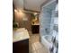 Modern bathroom featuring dual vanities and a tub with stylish marble-look tiling, offering ample space at 1817 Dartmouth Dr, Holiday, FL 34691