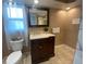 Bright bathroom featuring a white toilet and a vanity with a quartz countertop and modern fixtures at 1817 Dartmouth Dr, Holiday, FL 34691