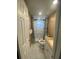 Bathroom features tiled shower and floors, a white vanity, and a neutral paint at 1817 Dartmouth Dr, Holiday, FL 34691