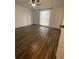 Bedroom features wood-look flooring and a large window at 1817 Dartmouth Dr, Holiday, FL 34691