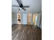 Bedroom features wood-look flooring, closet, and ensuite bathroom at 1817 Dartmouth Dr, Holiday, FL 34691