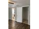 Bedroom features wood-look flooring, closet, and ensuite bathroom at 1817 Dartmouth Dr, Holiday, FL 34691