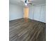 Bedroom with wood-look flooring, ceiling fan, and double closets at 1817 Dartmouth Dr, Holiday, FL 34691