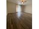 Bedroom with a ceiling fan, wood flooring, and a sliding glass door at 1817 Dartmouth Dr, Holiday, FL 34691