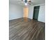 Bedroom with wood-look flooring and double closets at 1817 Dartmouth Dr, Holiday, FL 34691