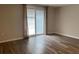 Bedroom featuring a sliding glass door and wood flooring at 1817 Dartmouth Dr, Holiday, FL 34691