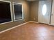 Entryway featuring decorative tiled floor, white front door with window, and two windows with blinds at 1817 Dartmouth Dr, Holiday, FL 34691