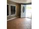 Entryway featuring decorative tiled floor, white front door with window, and two windows with blinds at 1817 Dartmouth Dr, Holiday, FL 34691