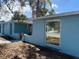 Charming exterior with well-maintained blue paint and front gate at 1817 Dartmouth Dr, Holiday, FL 34691