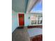 Inviting front entryway with a bright red door and decorative wreath at 1817 Dartmouth Dr, Holiday, FL 34691