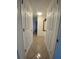 View of hallway with tiled floors and neutral-toned walls, offering access to various rooms at 1817 Dartmouth Dr, Holiday, FL 34691