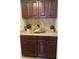 Kitchen with brown cabinets and a basket accessory on the counter at 1817 Dartmouth Dr, Holiday, FL 34691