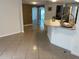 Open concept kitchen and living area with tiled floors at 1817 Dartmouth Dr, Holiday, FL 34691