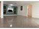 Spacious living room with built-in shelving and tiled floors at 1817 Dartmouth Dr, Holiday, FL 34691