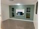 Cozy living room featuring a green accent wall with built in shelves at 1817 Dartmouth Dr, Holiday, FL 34691