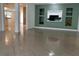 Open-concept living room featuring tile flooring and decorative shelving at 1817 Dartmouth Dr, Holiday, FL 34691