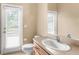 Bright half bathroom featuring a mirrored wall, natural lighting, and modern fixtures at 1824 Mountain Ash Way, New Port Richey, FL 34655