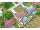 Aerial view showing the shape of the house, backyard pool, and surrounding properties at 2013 Meredith Dr, Spring Hill, FL 34608