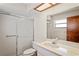 Bright bathroom features tile shower with glass door, vanity with sink, and tiled floor at 2013 Meredith Dr, Spring Hill, FL 34608