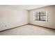 Bedroom featuring light-colored carpet, trim and walls plus a window at 2013 Meredith Dr, Spring Hill, FL 34608
