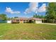 Attractive single-Gathering home with beautiful lawn and tidy shrubbery on a partly cloudy day at 2013 Meredith Dr, Spring Hill, FL 34608
