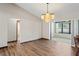 Open-concept living room with wood flooring, light walls, and a view into the sunroom at 2013 Meredith Dr, Spring Hill, FL 34608