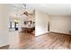 Open-concept living space featuring laminate floors, ceiling fan, and seamless flow into the kitchen at 2013 Meredith Dr, Spring Hill, FL 34608