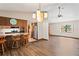 Open living space featuring wood floors, kitchen with barstool seating, and ample natural light at 2013 Meredith Dr, Spring Hill, FL 34608