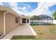 Back patio featuring access to a screened-in pool, ideal for outdoor entertaining and relaxation at 2013 Meredith Dr, Spring Hill, FL 34608