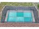 Aerial view of a sparkling turquoise pool enclosed by a well-maintained screen, creating a private outdoor oasis at 2013 Meredith Dr, Spring Hill, FL 34608
