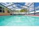 The clear, inviting water of the screened pool creates a luxurious and relaxing backyard experience at 2013 Meredith Dr, Spring Hill, FL 34608