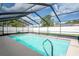 A sparkling pool enclosed by a screen, offering a perfect blend of sunshine and refreshing water at 2013 Meredith Dr, Spring Hill, FL 34608