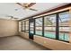 Enclosed sunroom featuring large windows overlooking a screened-in pool area, providing seamless indoor-outdoor living at 2013 Meredith Dr, Spring Hill, FL 34608