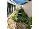 Relaxing atrium with a water feature, abundant plants, and a stone pathway at 355 Royal Palm Way, Spring Hill, FL 34608