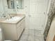 Well-lit bathroom featuring a vanity with storage, a neutral countertop, and a tile floor at 355 Royal Palm Way, Spring Hill, FL 34608