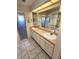 Bright bathroom featuring double sinks, spacious countertop, and a decorative glass shower door with a palm tree design at 355 Royal Palm Way, Spring Hill, FL 34608