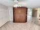 Cozy bedroom features tile floor, and natural light, adjacent to walkout door at 355 Royal Palm Way, Spring Hill, FL 34608