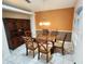 Formal dining room features a glass table, hutch, and seating for six at 355 Royal Palm Way, Spring Hill, FL 34608