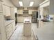 Bright kitchen with stainless steel appliances, white cabinetry, and a central island sink at 355 Royal Palm Way, Spring Hill, FL 34608