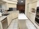 Spacious kitchen featuring an island sink and access to the dining area at 355 Royal Palm Way, Spring Hill, FL 34608