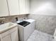Laundry room featuring a sink, modern washer and dryer set, and ample cabinet space at 355 Royal Palm Way, Spring Hill, FL 34608