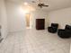 Spacious living area features neutral tones, tile floors, and comfortable black chairs at 355 Royal Palm Way, Spring Hill, FL 34608