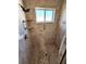 Tiled walk-in shower stall featuring a handheld shower head, grab bar, a built in shelf, and a bright window at 355 Royal Palm Way, Spring Hill, FL 34608