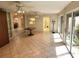 Bright sunroom features neutral tile, glass doors to the exterior and additional interior access at 355 Royal Palm Way, Spring Hill, FL 34608