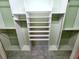 Open walk-in closet features multiple shelves and closet rods for ample storage space at 355 Royal Palm Way, Spring Hill, FL 34608