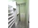 Organized walk-in closet offers shelves, clothing rods, and drawers for optimal storage at 355 Royal Palm Way, Spring Hill, FL 34608